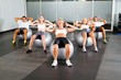 group of people doing workout with fitness balls in gym