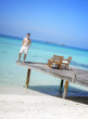 Sexy happy man standing on a jetty (Maldives / Malediven)