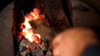 Blacksmith at work, melting iron in a small furnace