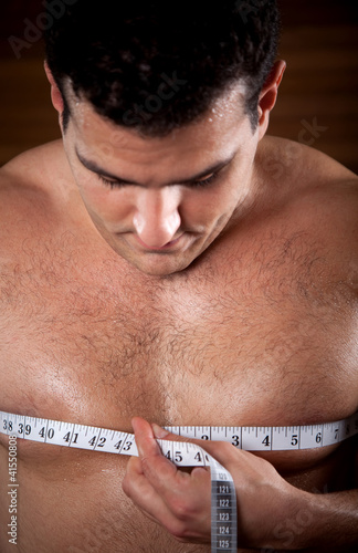 Photo: Man measuring his chest Man measuring his chest