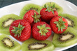 Kiwi and strawberries on a white dish Kiwi and strawberries on a white dish