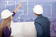 Foto : Architects looking at blueprints Architects looking at blueprints