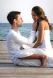 Beautiful love couple on a jetty by the sea (Maldives)