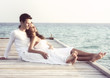 Beautiful love couple on a jetty by the sea (Maldives)