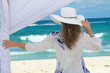 Photo: Woman under a gazebo looking at the sea. Woman under a gazebo looking at the sea.