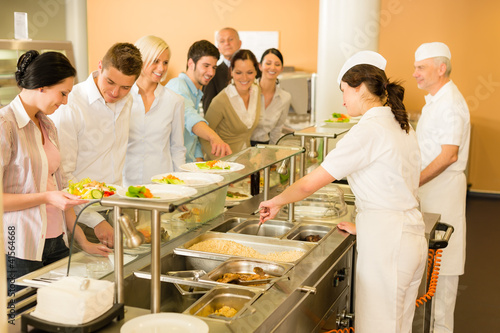 Photo: Office woman in canteen cook serve meals Office woman in canteen cook serve meals