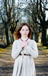 Young woman in vintage dress pray