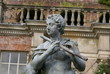 statue of man playing flute