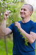 Agronomist checking cherry tree flowers