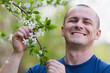 Agronomist checking cherry tree flowers