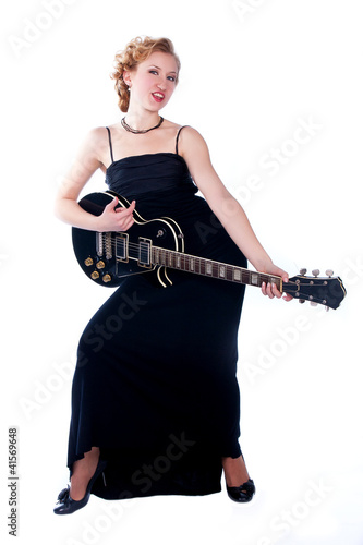 Foto: woman playing electricguitar on studio isolated white backgr woman playing electricguitar on studio isolated white backgr