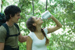 Hiking couple, woman drinking water