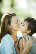 Mother and son, woman kissing boy on cheek