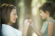 Mother and son sitting outdoors, playing together