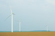 Wind turbines in plowed field