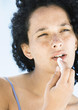 Woman applying lip balm