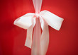 White bow on red package, close-up