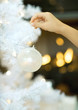 Photo: Child hanging christmas ornament on tree Child hanging christmas ornament on tree