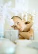 Girl lying on floor next to Christmas tree
