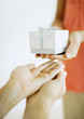Hands giving and receiving gift