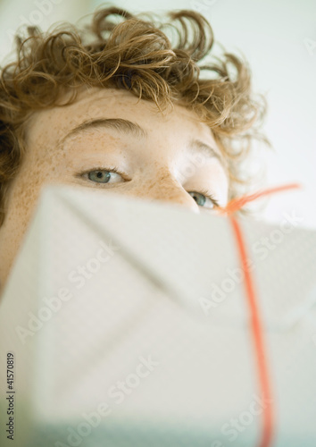 Foto: Boy looking over edge of present Boy looking over edge of present