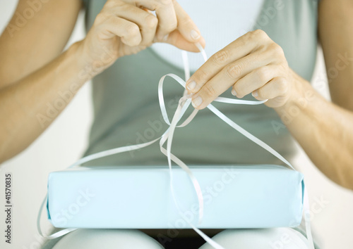 Photo: Woman wrapping present Woman wrapping present