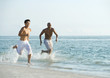 Two men running in surf