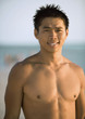 Barechested man on beach, portrait