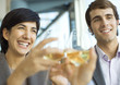Executives clinking glasses of wine, close-up