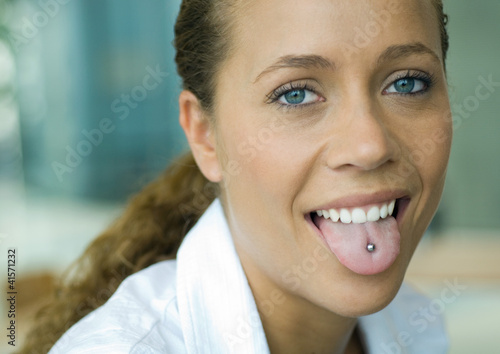 Photo: Professional woman, showing pierced tongue, portrait Professional woman, showing pierced tongue, portrait