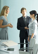 Businessman introducing teenage girl to young professional woman