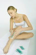 Woman applying cold wax strips