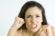Woman making angry face, holding up fists, portrait