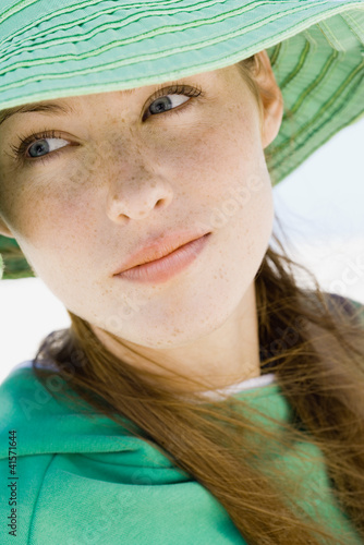 Photo: Young woman wearing sun hat, close-up Young woman wearing sun hat, close-up