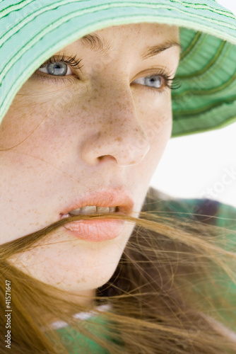 Photo: Young woman wearing sun hat, close-up Young woman wearing sun hat, close-up
