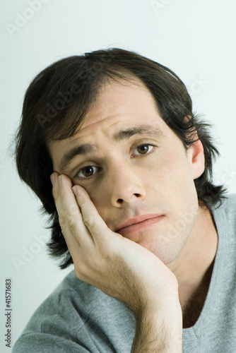 Photo: Man, holding head, portrait Man, holding head, portrait