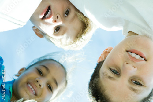 Photo: Three children, low angle view Three children, low angle view