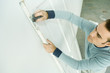 Man scouring hinge on door, high angle view