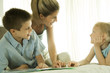 Mother helping children with homework