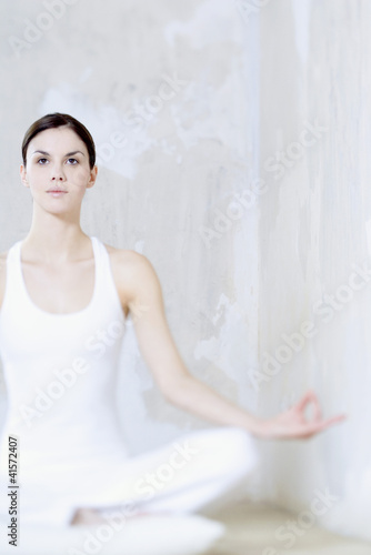 Photo: Woman sitting in lotus position, looking up Woman sitting in lotus position, looking up