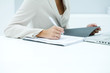 Businesswoman reading over file, cropped