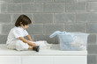Little boy folding laundry, side view
