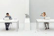 Photo: Woman sitting at desk with paper crumpled around her, looking through binoculars at neighboring coworker Woman sitting at desk with paper crumpled around her, looking through binoculars at neighboring coworker