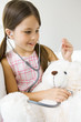 Photo: Little girl listening to teddy's bear's heart with stethoscope, looking at thermometer Little girl listening to teddy's bear's heart with stethoscope, looking at thermometer