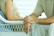 Couple sitting face to face, cropped view