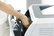 Person fixing printer, cropped view