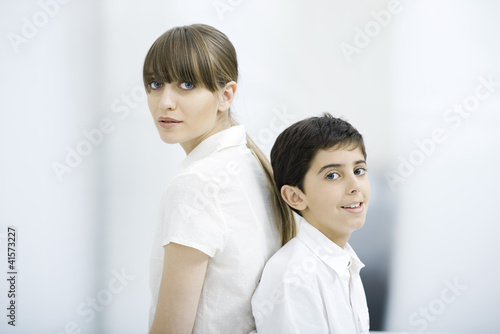 Photo: Mother and son back to back, portrait Mother and son back to back, portrait