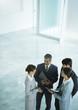 Four business associates talking together in lobby