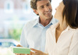 Man handing woman gift