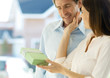 Woman handing man gift